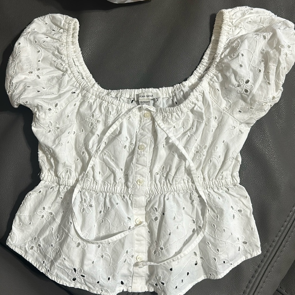 White Eyelets American Eagle top with buttons. Puffy sleeves. Size XS